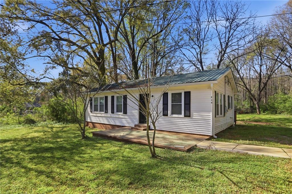714 Reed Street Monroe, GA 30655 - Photo 3 of 31 a front view of a house with a yard