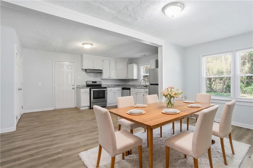 714 Reed Street Monroe, GA 30655 - Photo 5 of 31 a view of a dining room with furniture and wooden floor