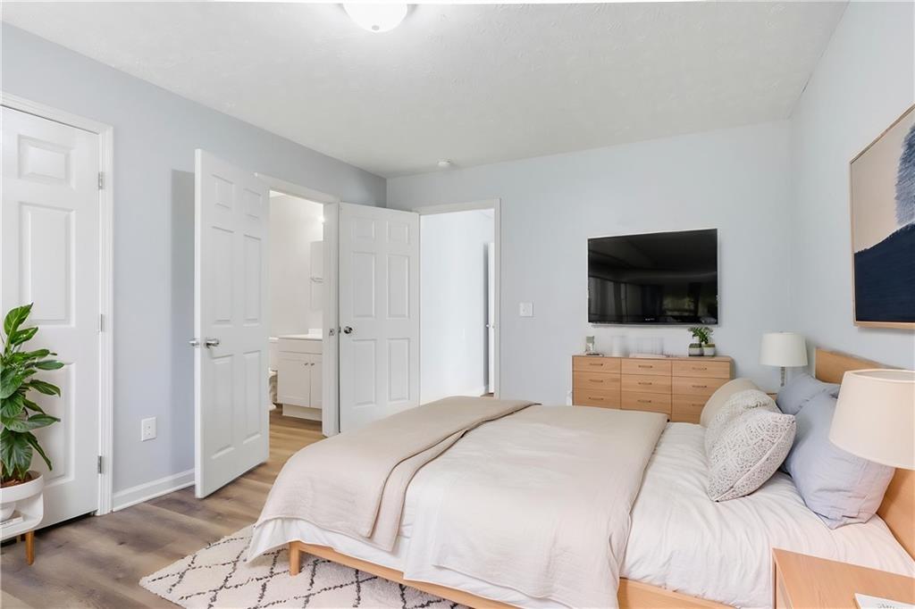 714 Reed Street Monroe, GA 30655 - Photo 8 of 31 a bedroom with a bed and a flat screen tv