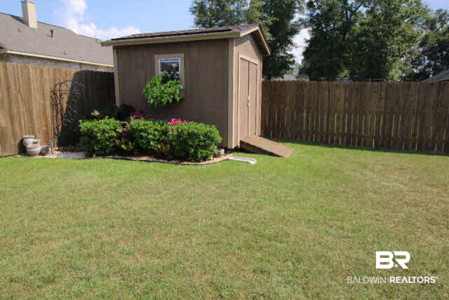 2242 Fernwood Loop West Semmes, AL 36575 - Photo 22 of 24 Storage Shed & completely fenced