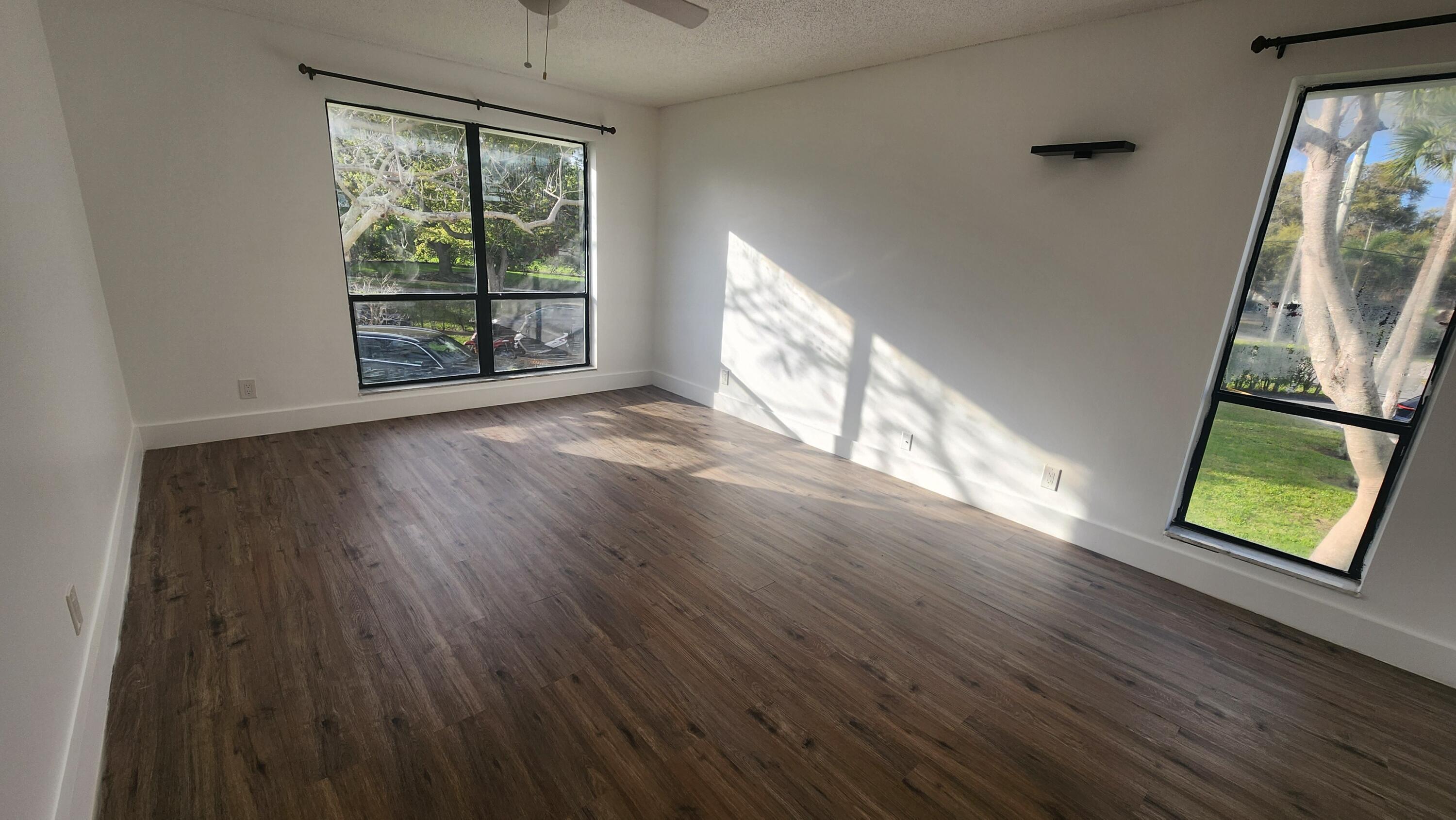 517 Dotterel Road, Unit 31C Delray Beach, FL 33444 - Photo 11 of 31 wooden floor in an empty room with a window
