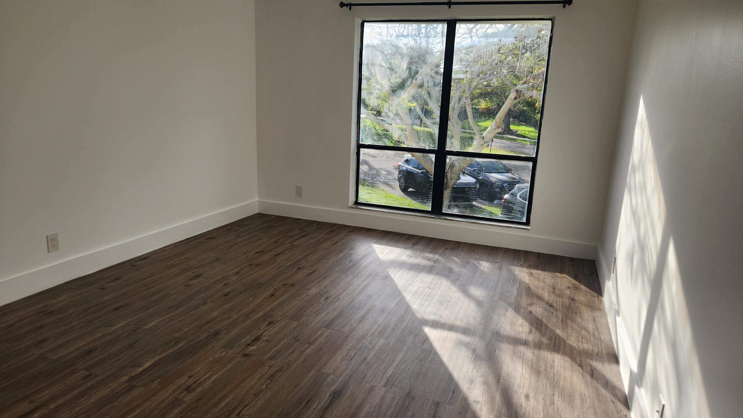 517 Dotterel Road, Unit 31C Delray Beach, FL 33444 - Photo 12 of 31 a view of a room with wooden floor and a window