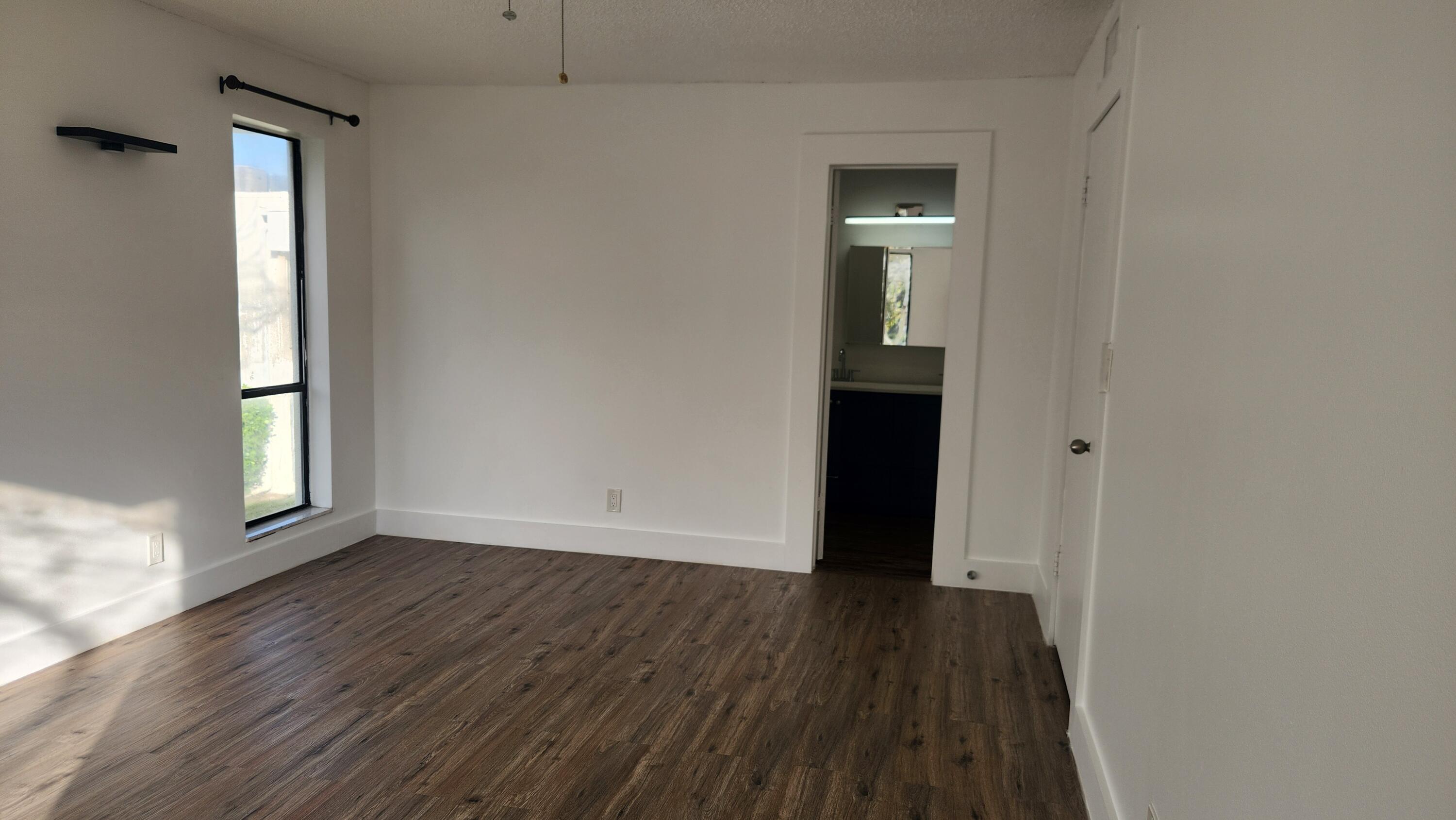 517 Dotterel Road, Unit 31C Delray Beach, FL 33444 - Photo 13 of 31 an empty room with wooden floor and windows
