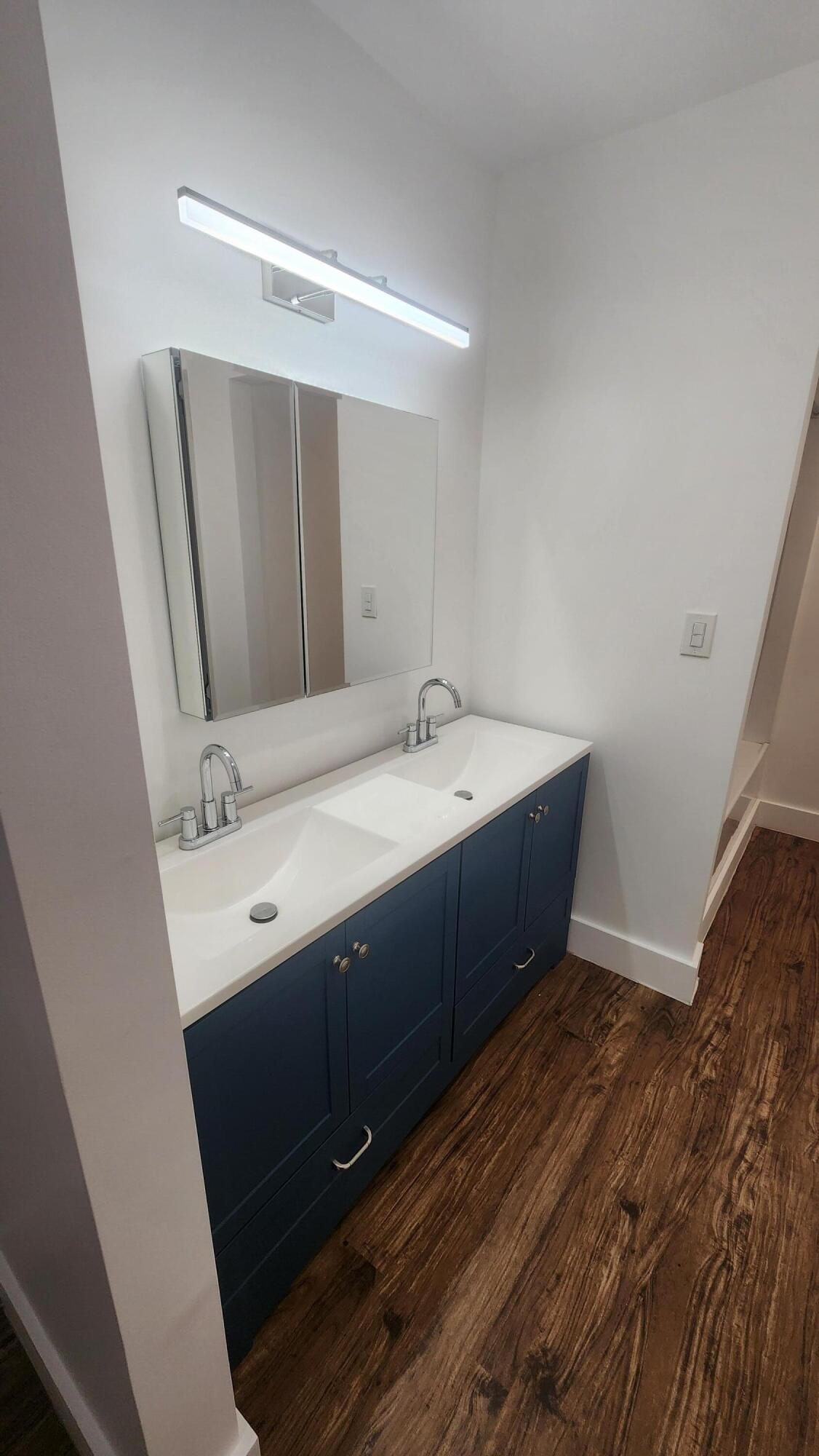 517 Dotterel Road, Unit 31C Delray Beach, FL 33444 - Photo 16 of 31 a bathroom with a double vanity sink and mirror