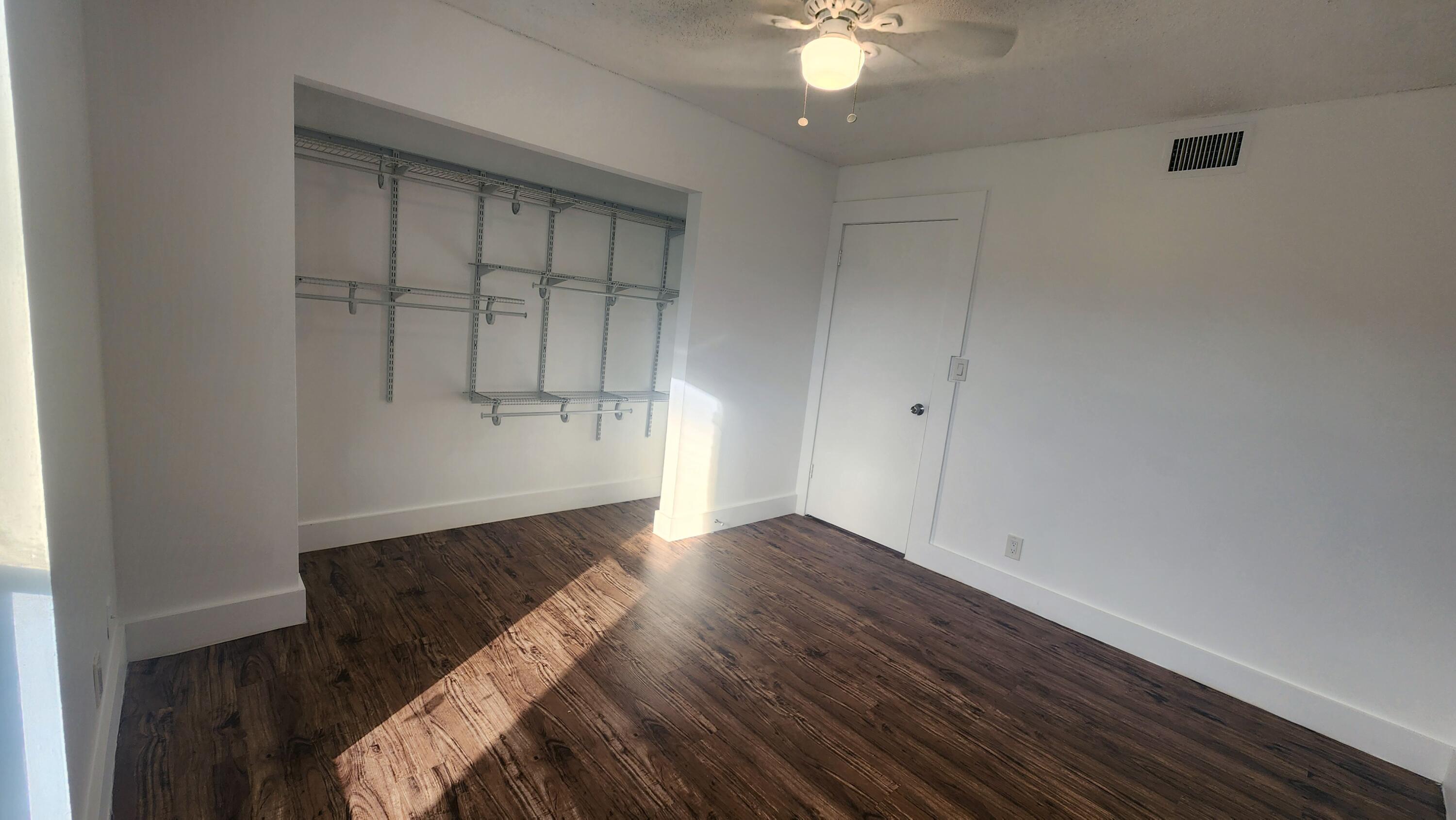 517 Dotterel Road, Unit 31C Delray Beach, FL 33444 - Photo 22 of 31 an empty room with wooden floor and cabinet