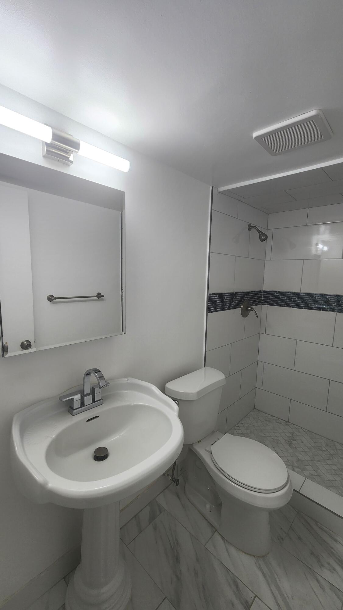 517 Dotterel Road, Unit 31C Delray Beach, FL 33444 - Photo 26 of 31 a white toilet sitting next to a bathroom sink