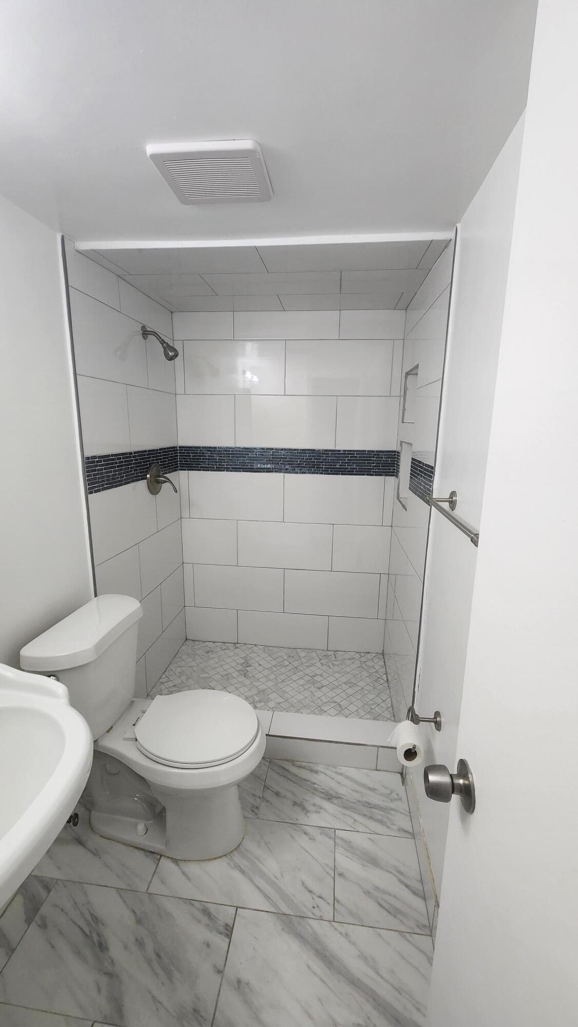 517 Dotterel Road, Unit 31C Delray Beach, FL 33444 - Photo 27 of 31 a bathroom with a toilet and a shower