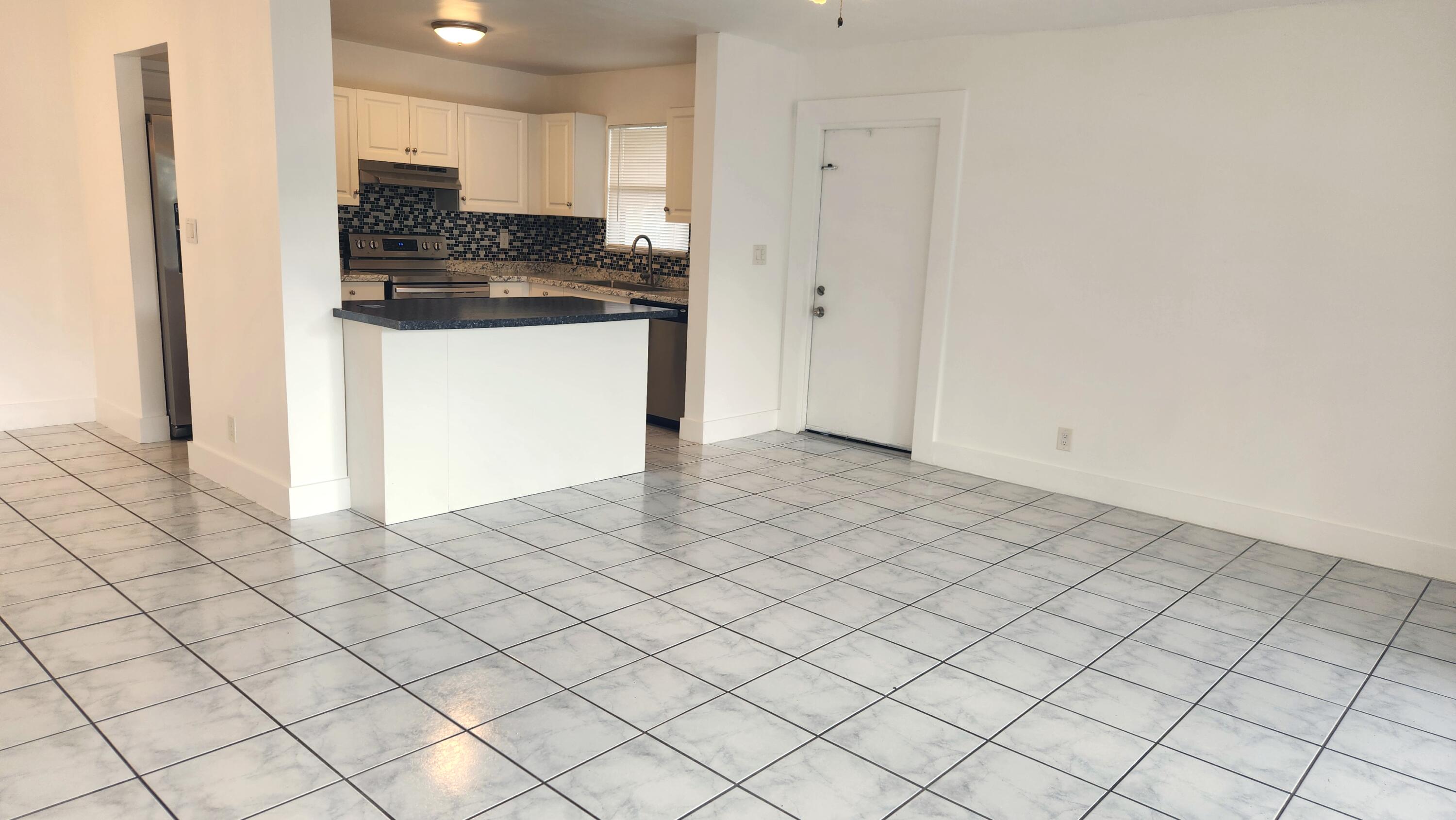 517 Dotterel Road, Unit 31C Delray Beach, FL 33444 - Photo 3 of 31 a kitchen with granite countertop white cabinets and stainless steel appliances