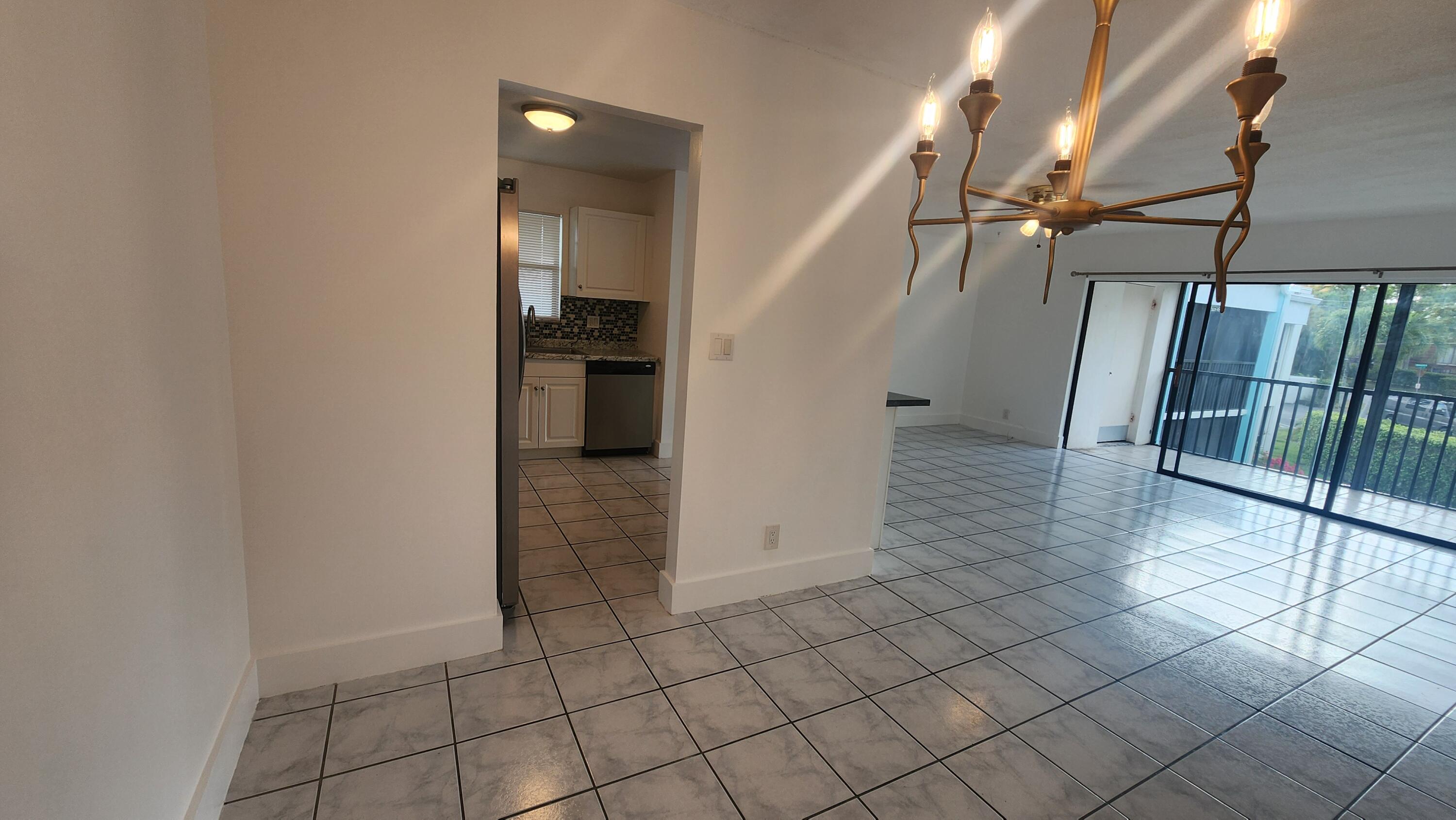 517 Dotterel Road, Unit 31C Delray Beach, FL 33444 - Photo 6 of 31 a view of hallway with stairs and a refrigerator