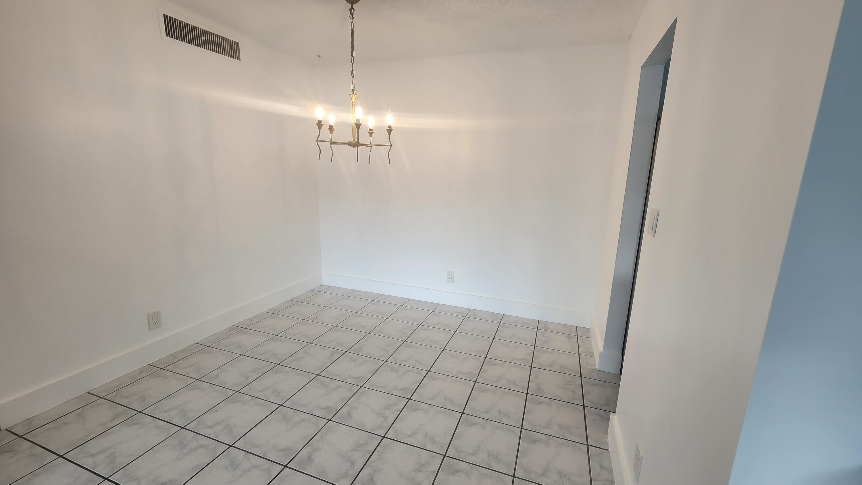517 Dotterel Road, Unit 31C Delray Beach, FL 33444 - Photo 7 of 31 a view of a chandelier in an empty room