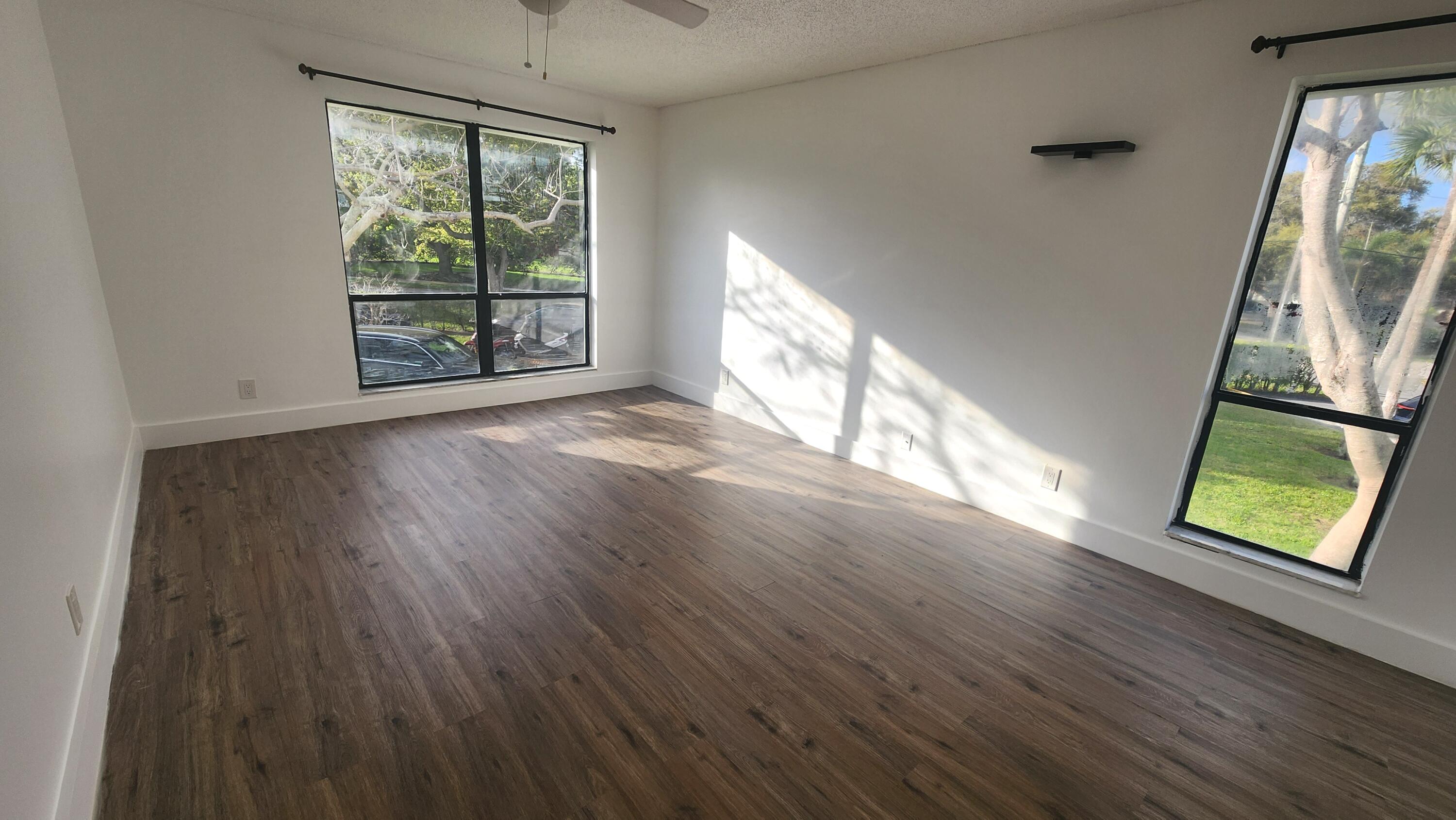 517 Dotterel Road, Unit 31C Delray Beach, FL 33444 - Photo 8 of 31 wooden floor in an empty room with a window