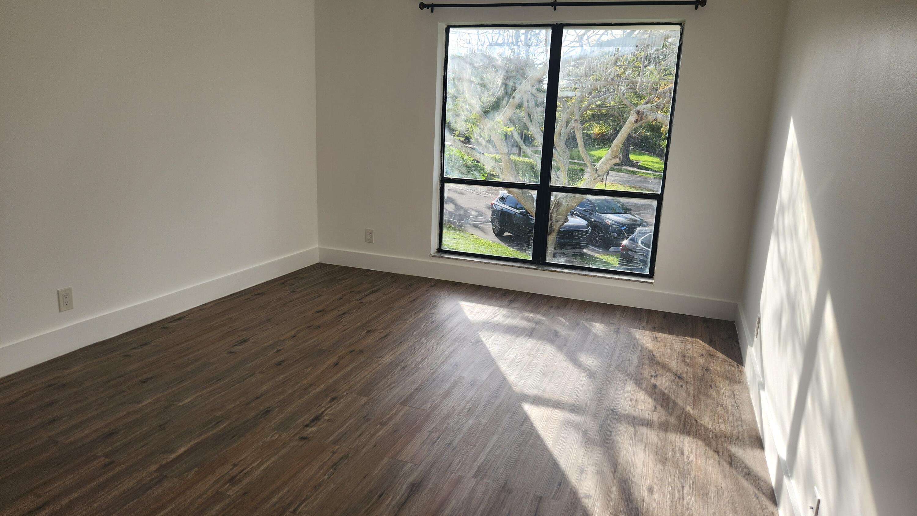 517 Dotterel Road, Unit 31C Delray Beach, FL 33444 - Photo 9 of 31 a view of a room with wooden floor and a window