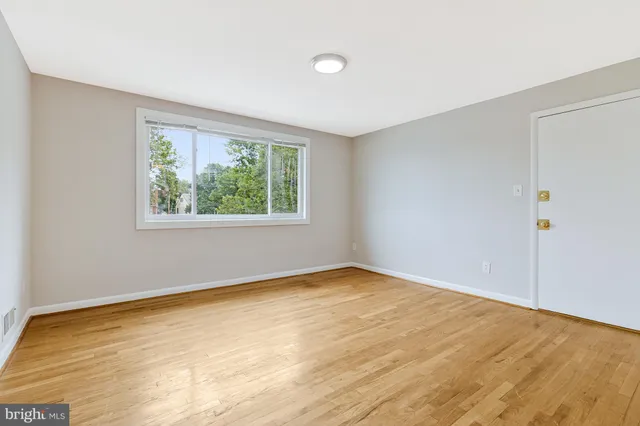 a view of walk in closet with wooden floor