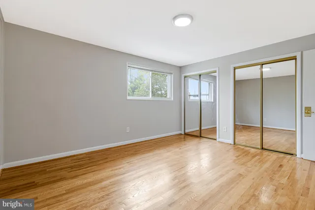 a view of staircase with white walls and empty racks