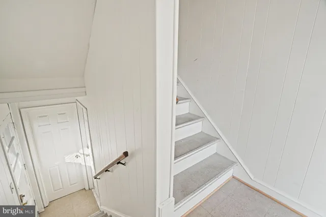 a view of a room with wooden floor and white walls