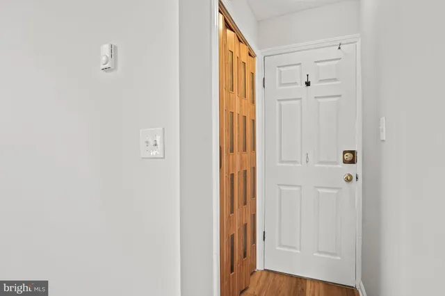 a view of an empty room with wooden floor