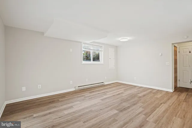 a view of an empty room and wooden floor