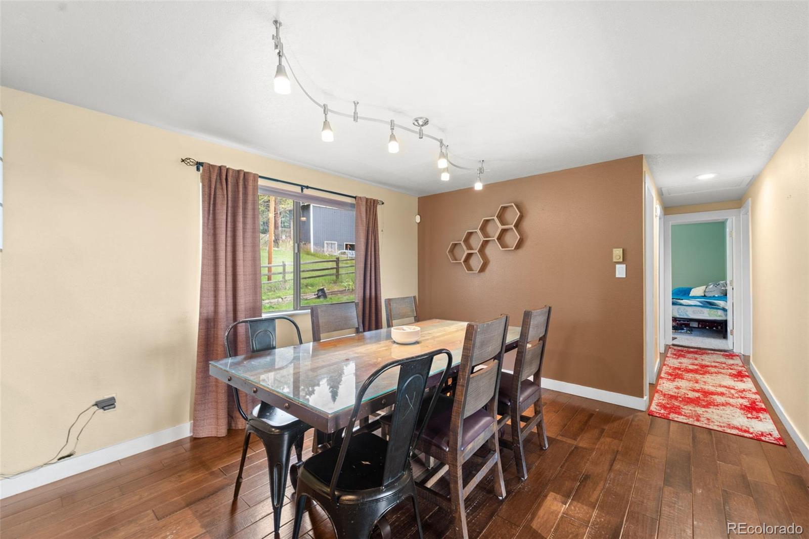 10829 Bartlett Trail Rye, CO 81069 - Photo 11 of 40 a view of a dining room with furniture window and wooden floor