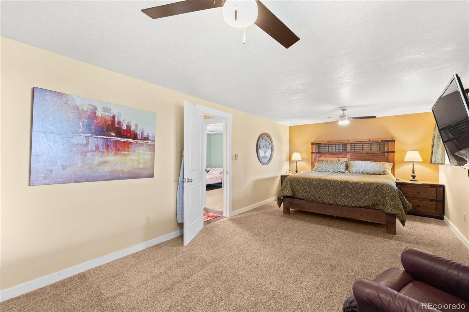 10829 Bartlett Trail Rye, CO 81069 - Photo 14 of 40 a bedroom with a bed and a painting on the wall