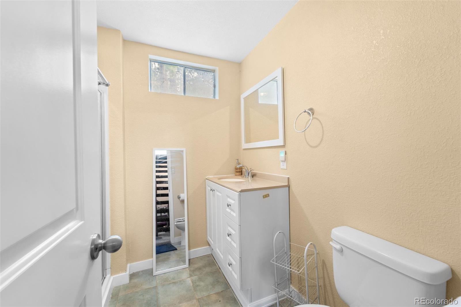 10829 Bartlett Trail Rye, CO 81069 - Photo 16 of 40 a bathroom with a granite countertop sink toilet and shower