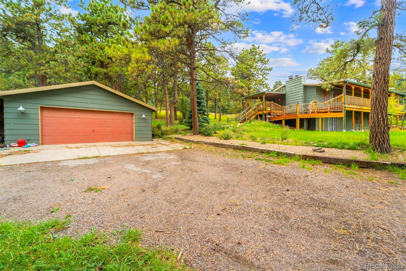 10829 Bartlett Trail Rye, CO 81069 - Photo 24 of 40 a front view of a house with a yard and garage
