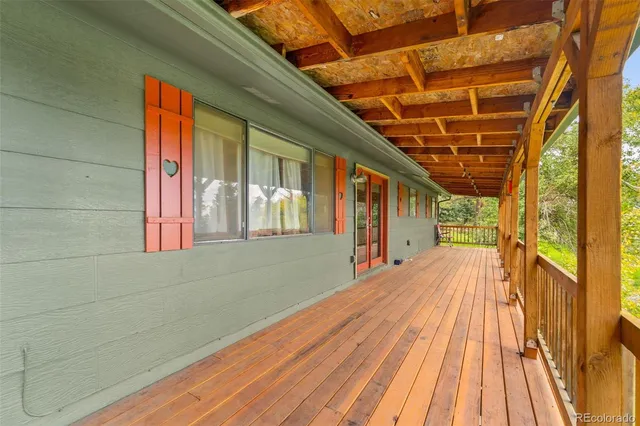 a view of backyard with a large window and wooden floor
