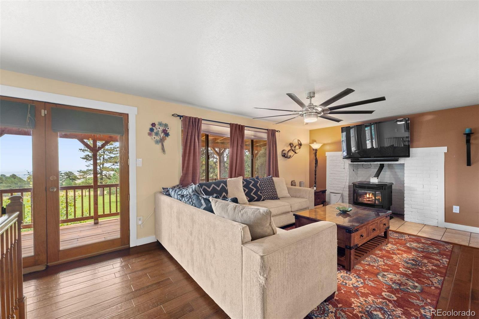10829 Bartlett Trail Rye, CO 81069 - Photo 5 of 40 a living room with fireplace furniture and a large window
