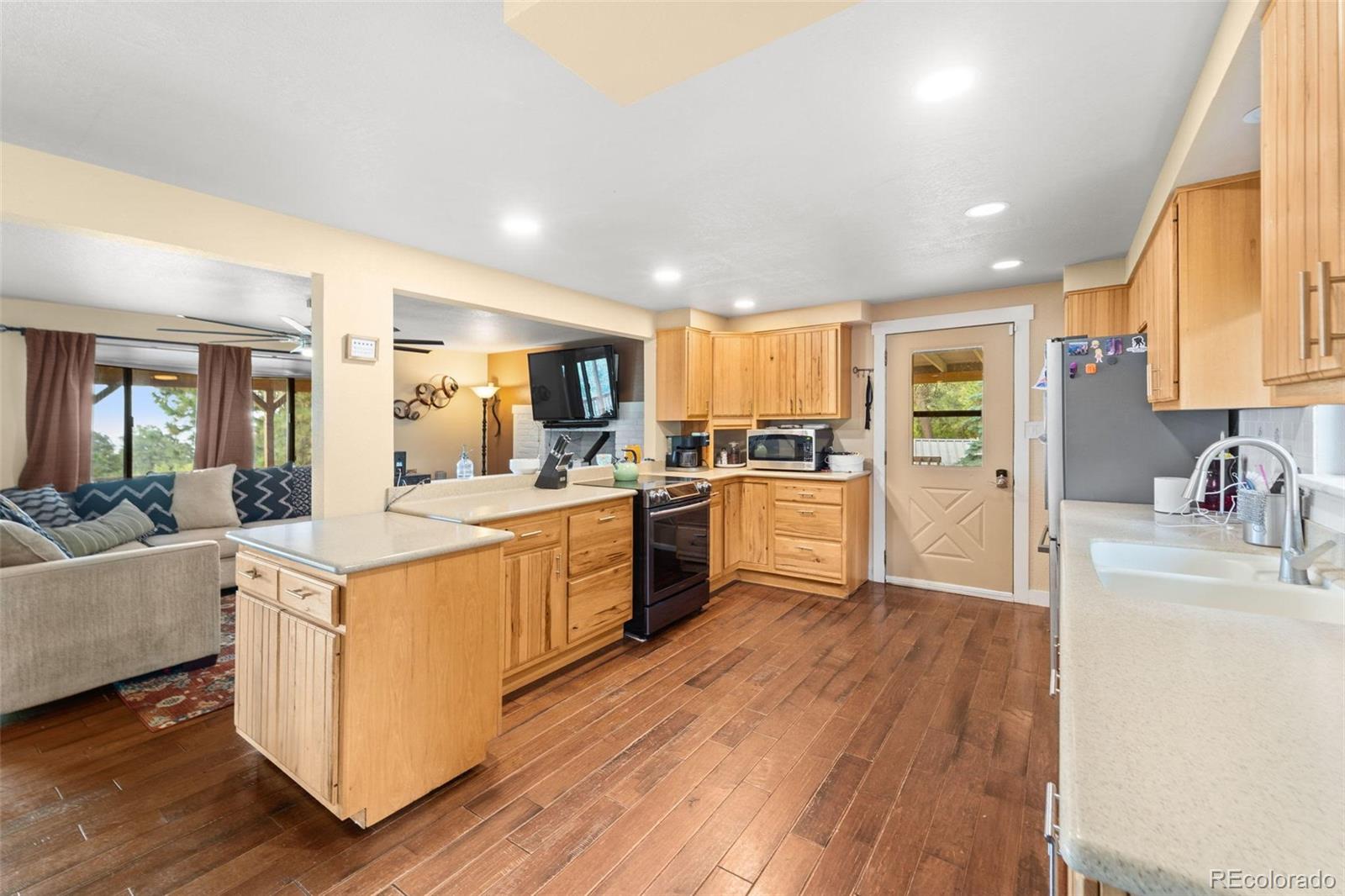 10829 Bartlett Trail Rye, CO 81069 - Photo 7 of 40 a kitchen with a sink wooden floor stainless steel appliances and cabinets