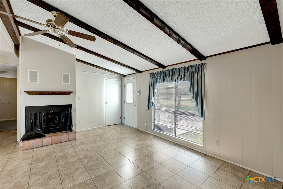 293 County Road 406 Edna, TX 77957 - Photo 11 of 48 a view of an empty room with a fireplace and a window