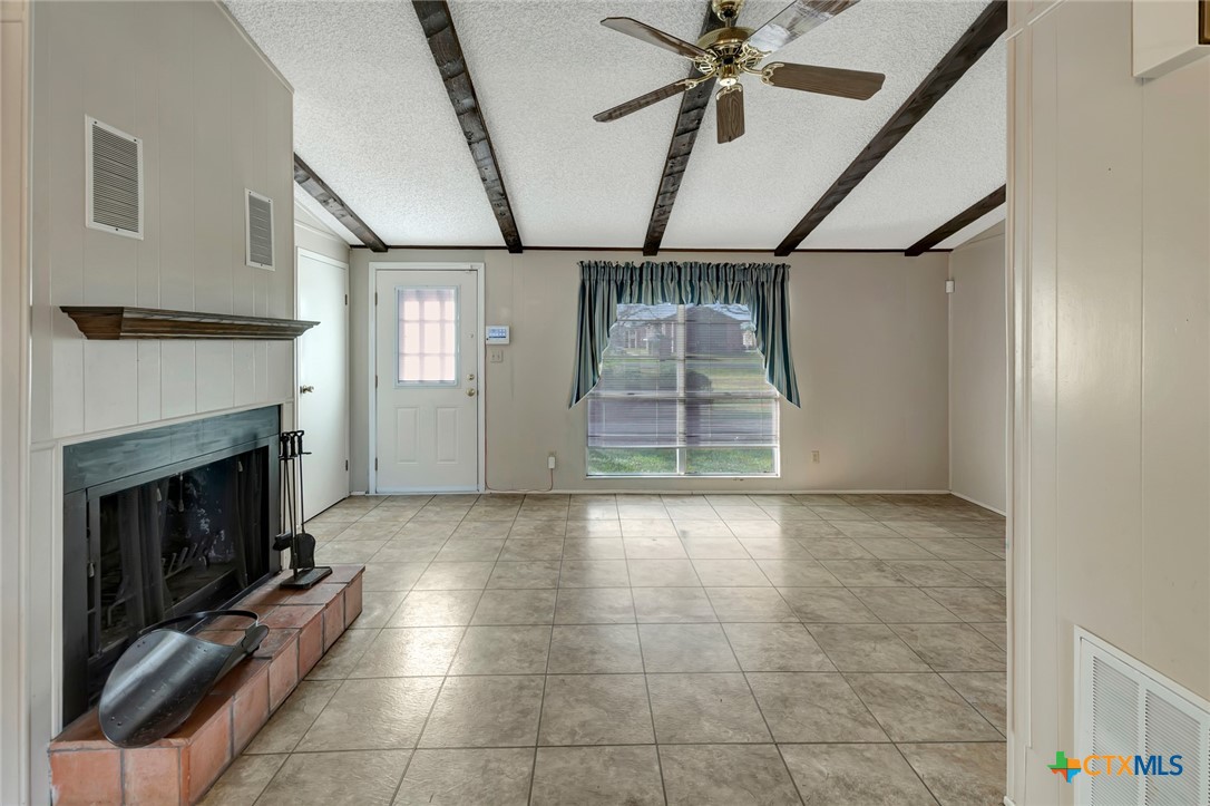 293 County Road 406 Edna, TX 77957 - Photo 14 of 48 a view of empty room with wooden floor and fireplace