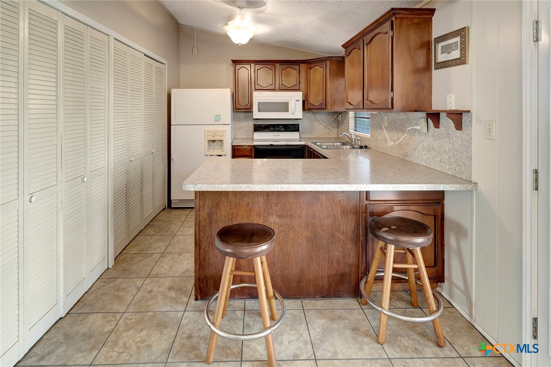 293 County Road 406 Edna, TX 77957 - Photo 17 of 48 a kitchen with a stove and a refrigerator