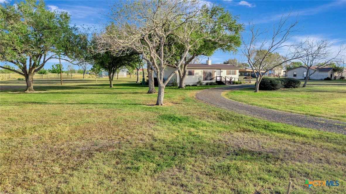 293 County Road 406 Edna, TX 77957 - Photo 2 of 48 a view of a house with a big yard and palm trees