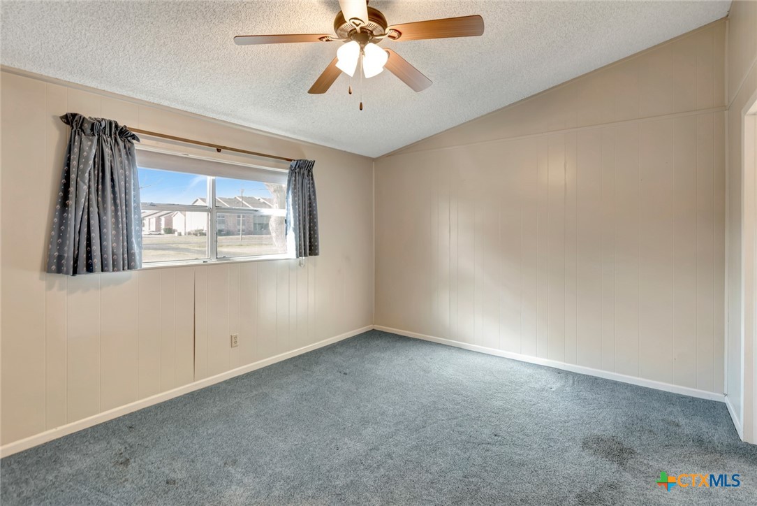 293 County Road 406 Edna, TX 77957 - Photo 22 of 48 an empty room with a window and a ceiling fan