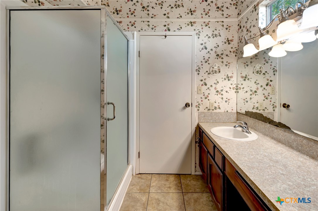 293 County Road 406 Edna, TX 77957 - Photo 28 of 48 a bathroom with a sink and a mirror