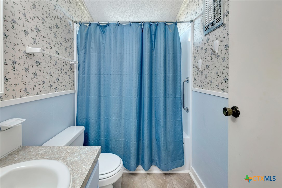293 County Road 406 Edna, TX 77957 - Photo 30 of 48 a bathroom with a sink and a toilet