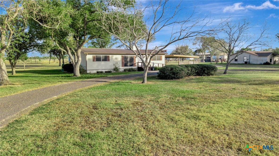 293 County Road 406 Edna, TX 77957 - Photo 4 of 48 a front view of a house with a yard