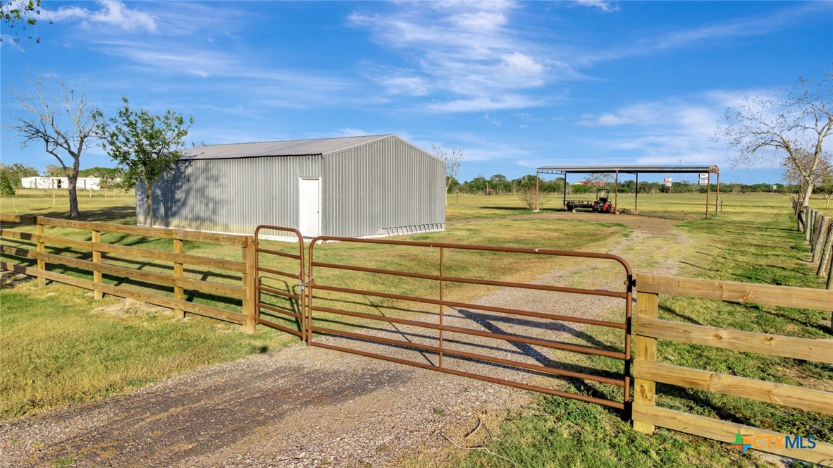293 County Road 406 Edna, TX 77957 - Photo 46 of 48 a view of a swimming pool with an outdoor seating and a yard