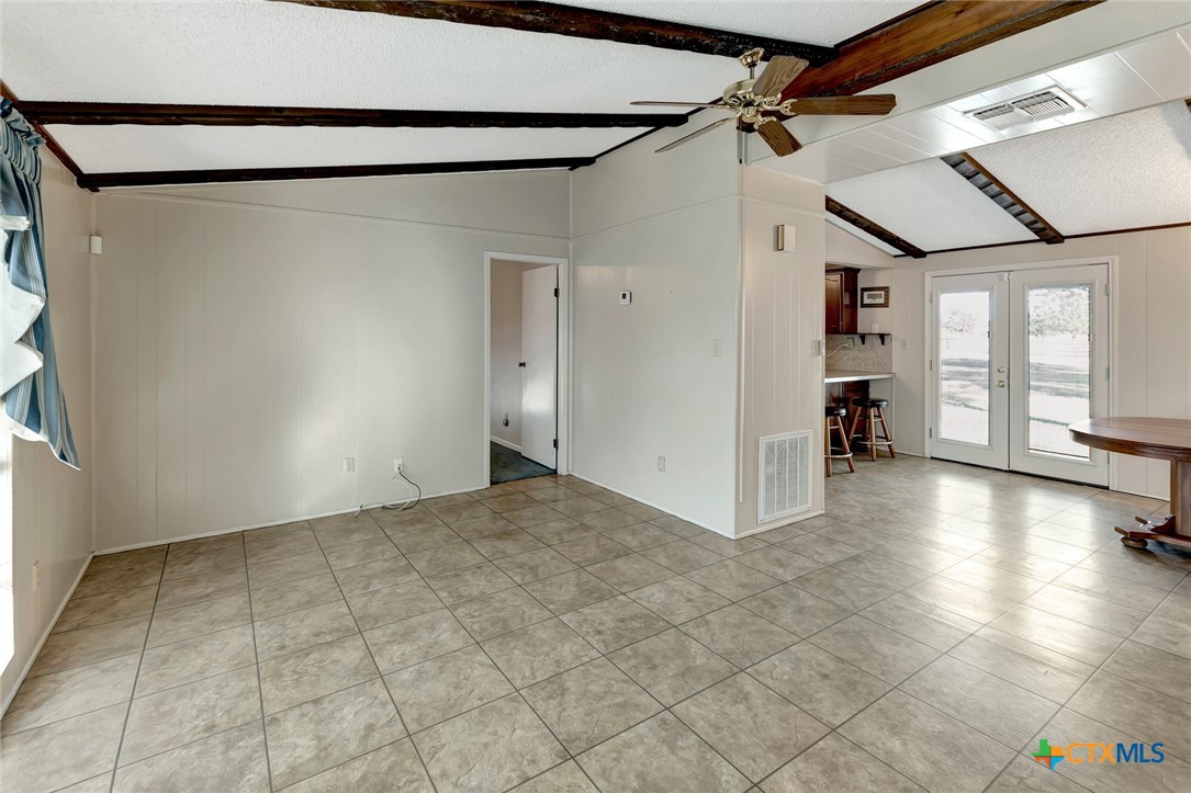 293 County Road 406 Edna, TX 77957 - Photo 10 of 48 a view of a livingroom with wooden floor and a ceiling fan