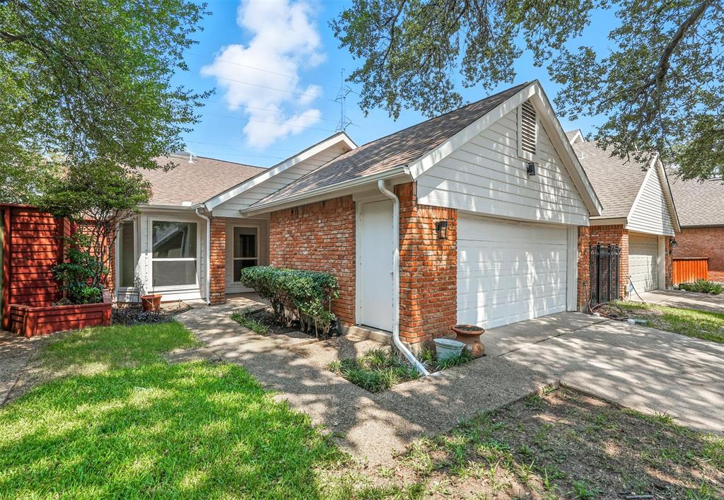 4049 Rive Lane Addison, TX 75001 - Photo 1 of 1 View of home's exterior featuring a shingled roof, brick siding, concrete driveway, and an attached garage