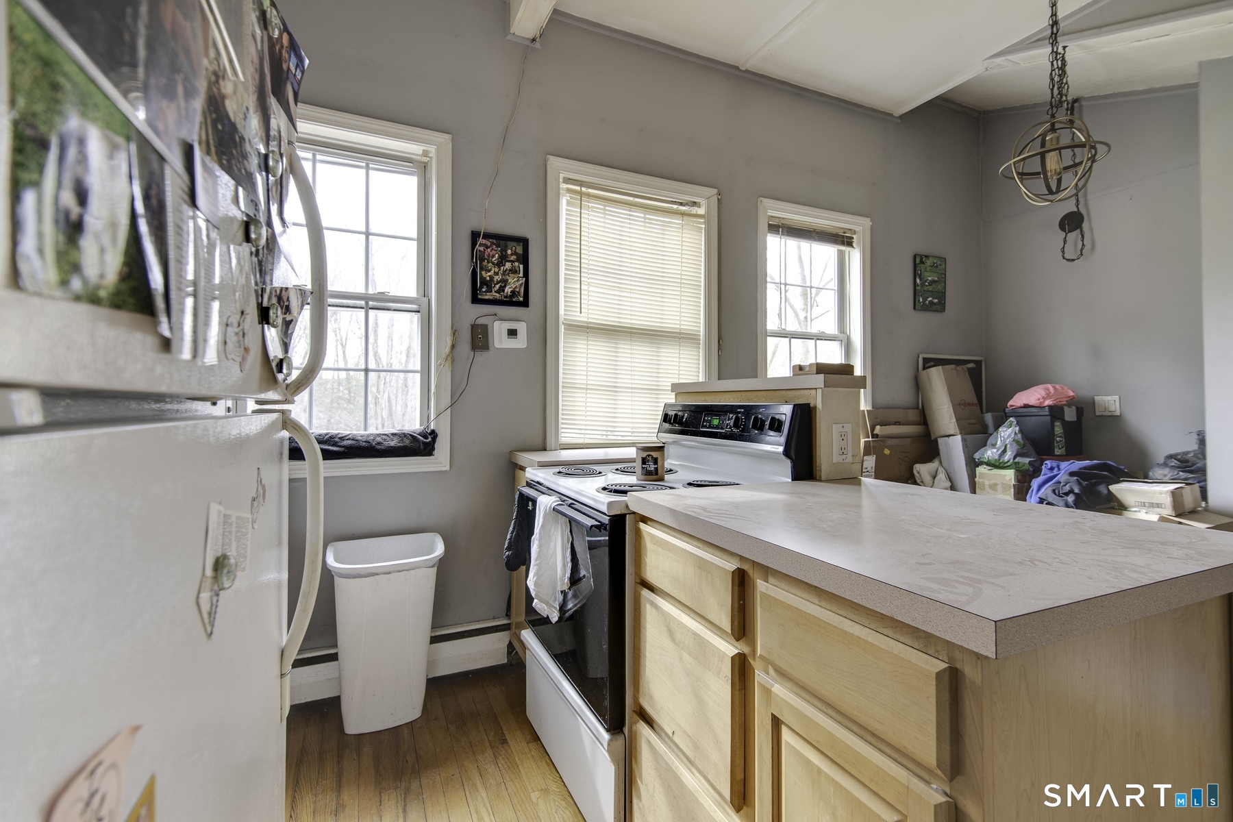 183 Sugar Street Newtown, CT 06470 - Photo 15 of 40 a kitchen with a stove a sink and a refrigerator