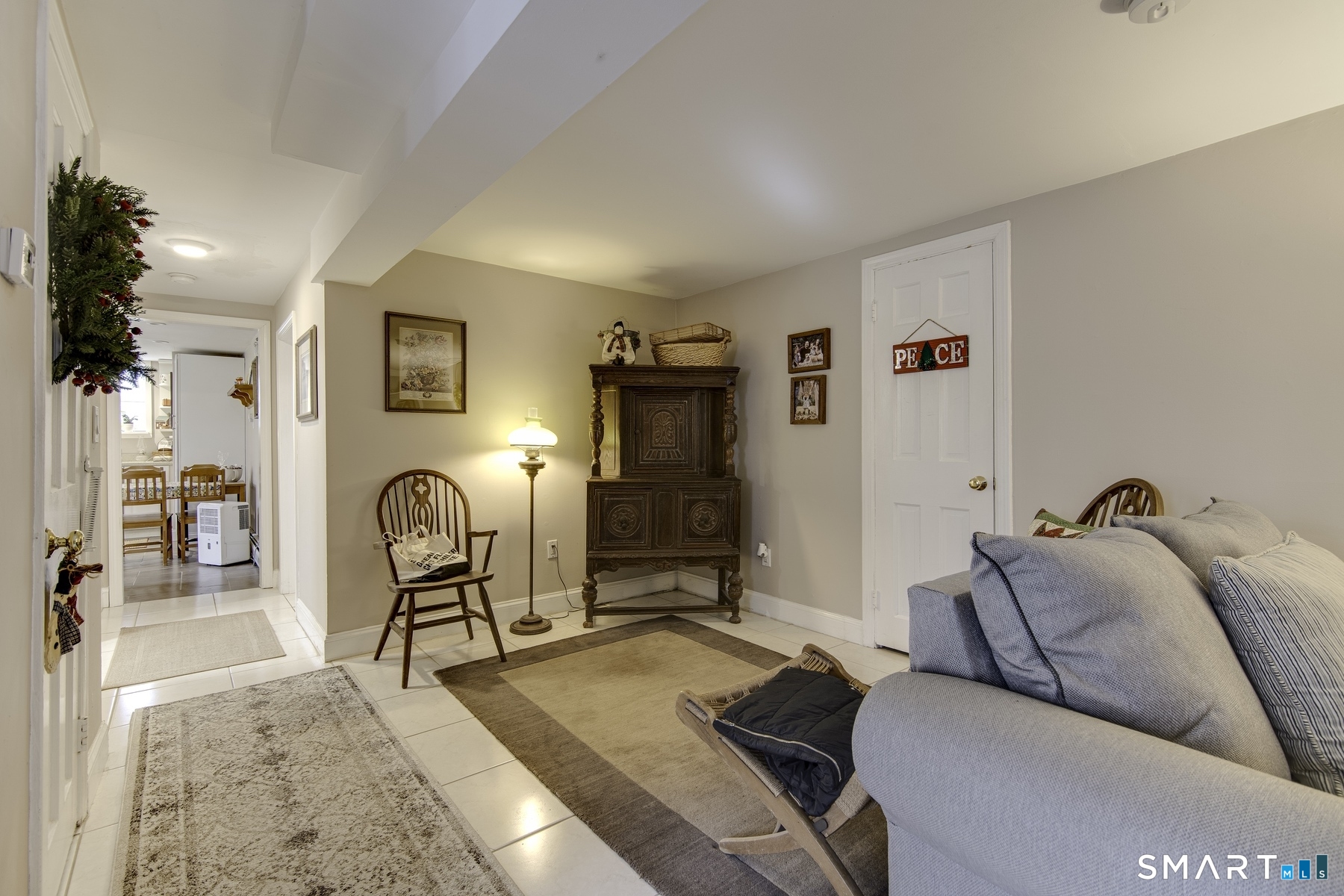 183 Sugar Street Newtown, CT 06470 - Photo 19 of 40 a living room with furniture a flat screen tv and a table