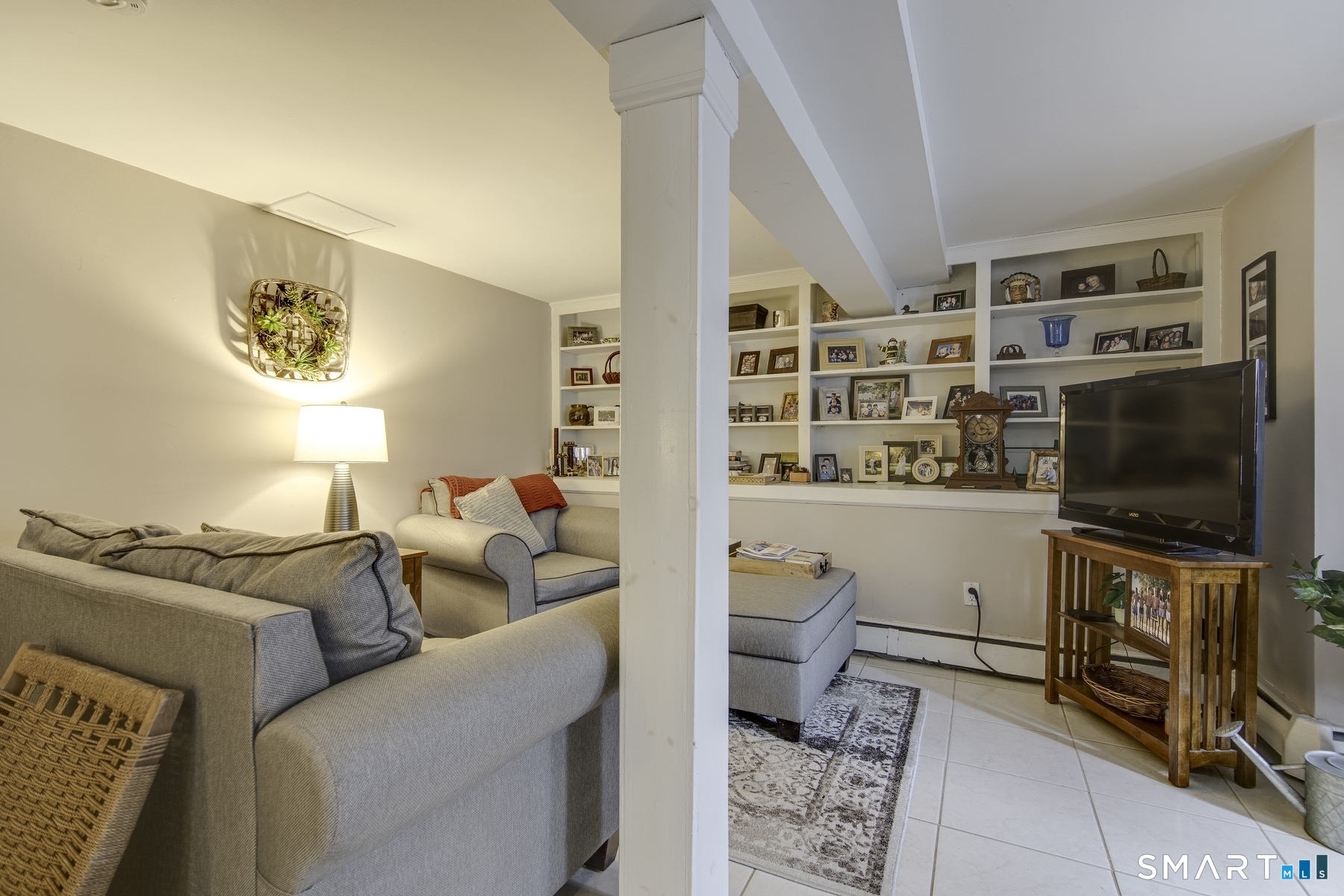 183 Sugar Street Newtown, CT 06470 - Photo 20 of 40 a living room with furniture and a flat screen tv