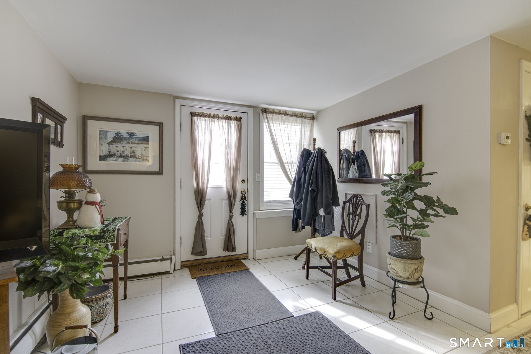 183 Sugar Street Newtown, CT 06470 - Photo 21 of 40 a living room with furniture a window and a potted plant