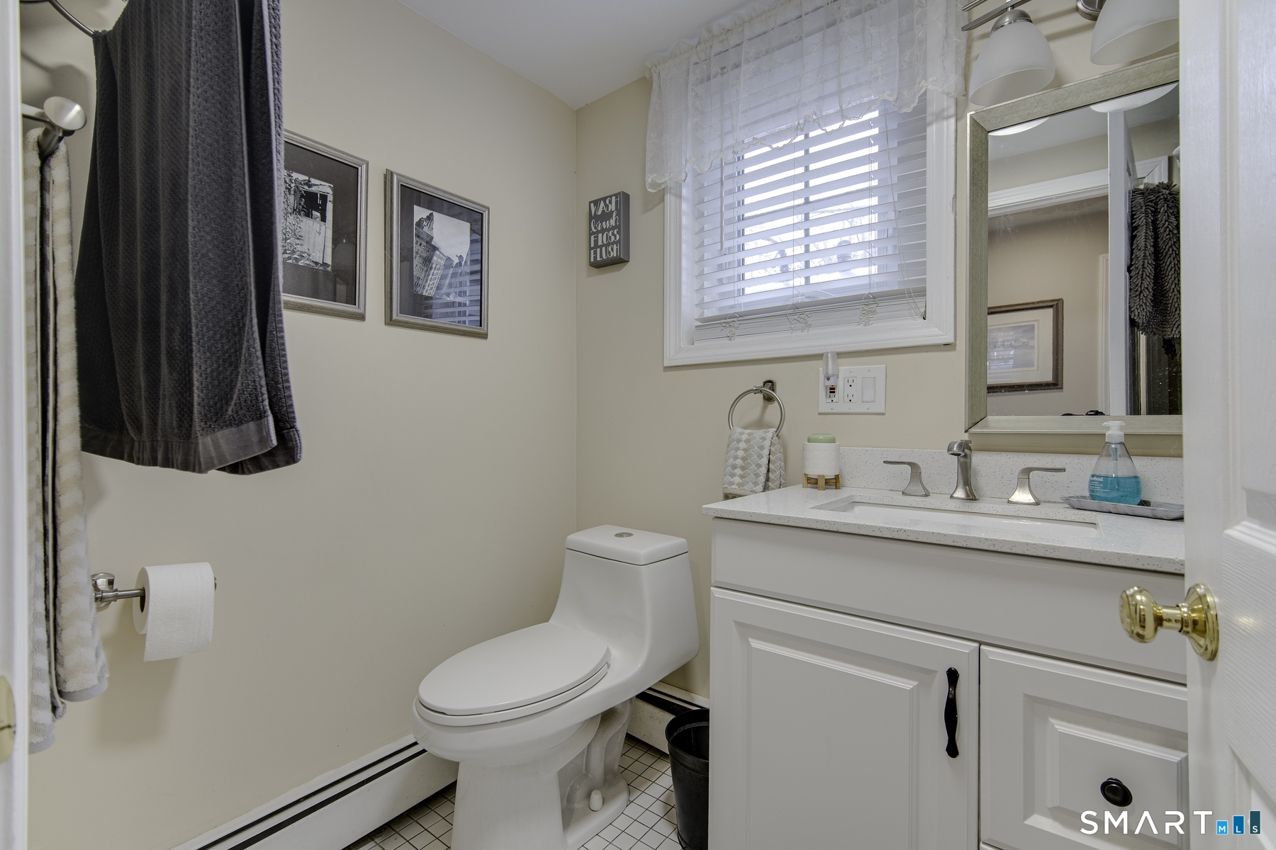 183 Sugar Street Newtown, CT 06470 - Photo 23 of 40 a bathroom with a toilet sink and mirror