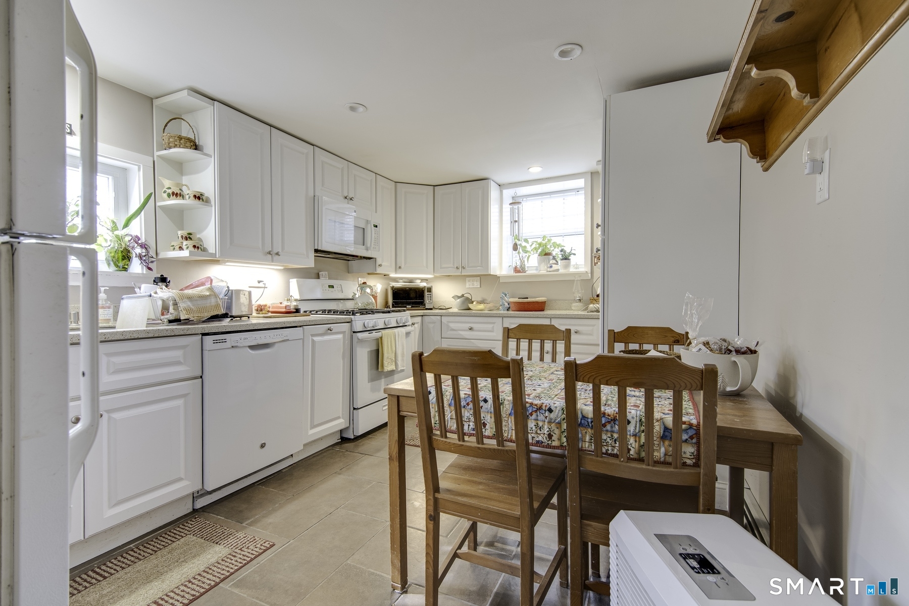 183 Sugar Street Newtown, CT 06470 - Photo 24 of 40 a kitchen that has a dining table chairs and a window