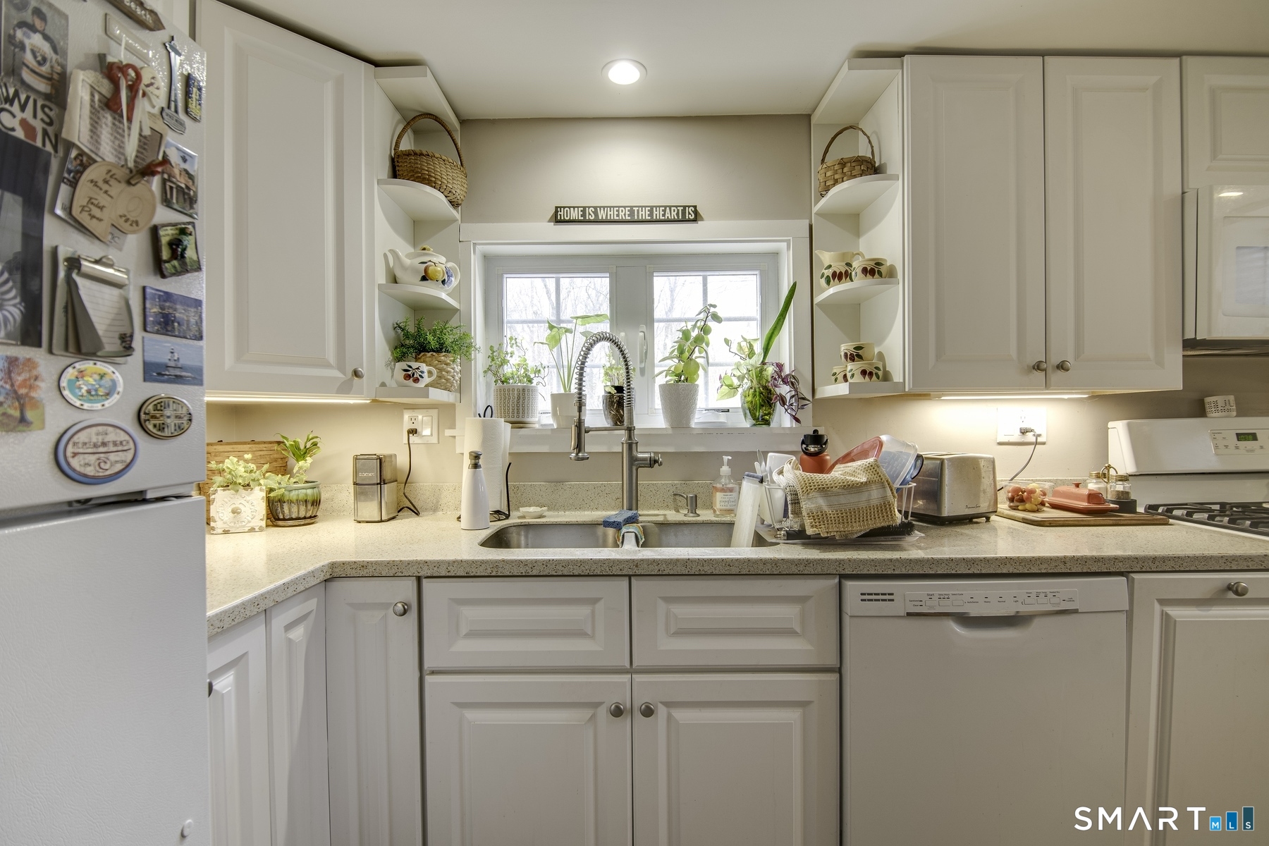 183 Sugar Street Newtown, CT 06470 - Photo 25 of 40 a kitchen with a sink a window and cabinets