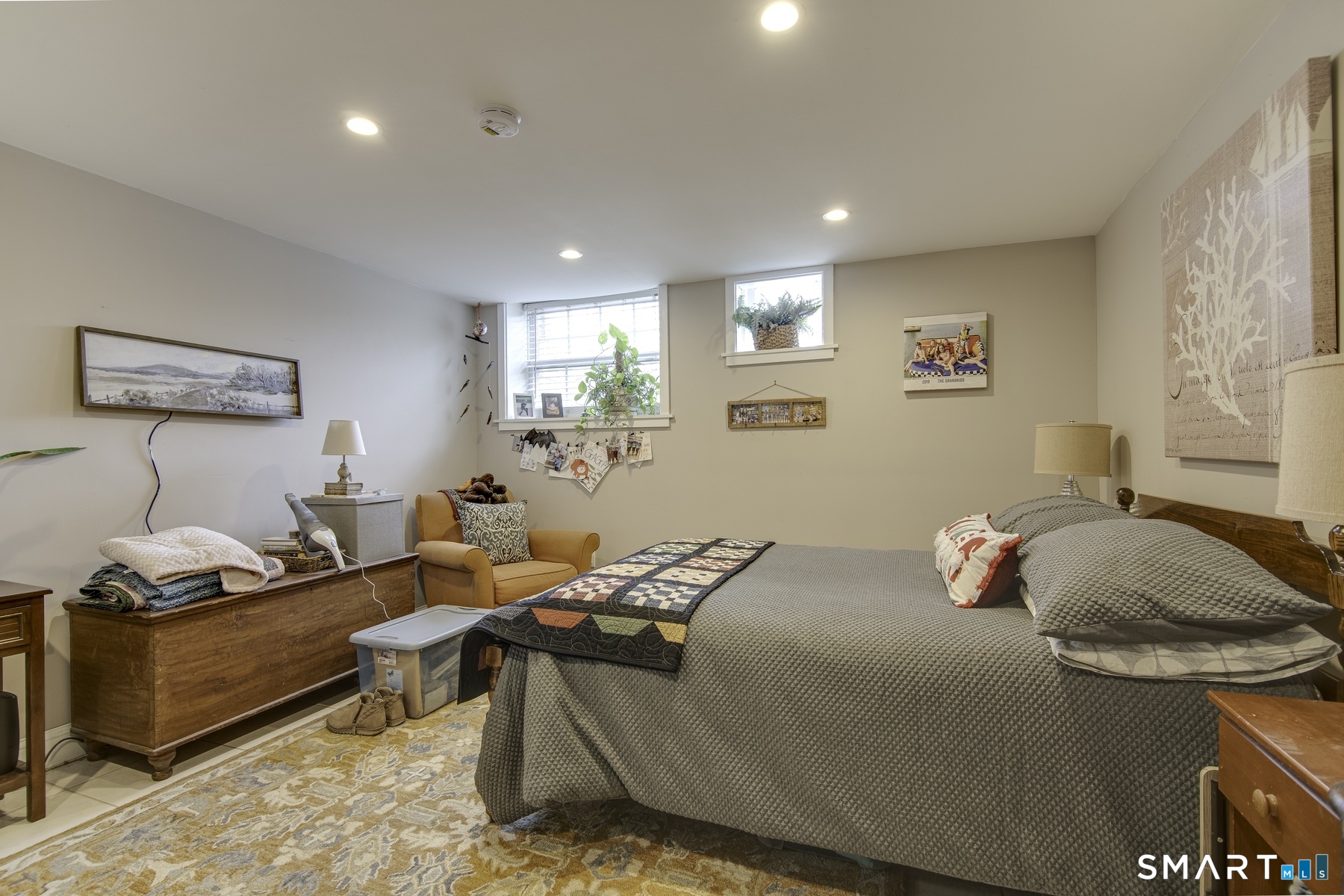 183 Sugar Street Newtown, CT 06470 - Photo 29 of 40 a bedroom with a bed and wooden floor