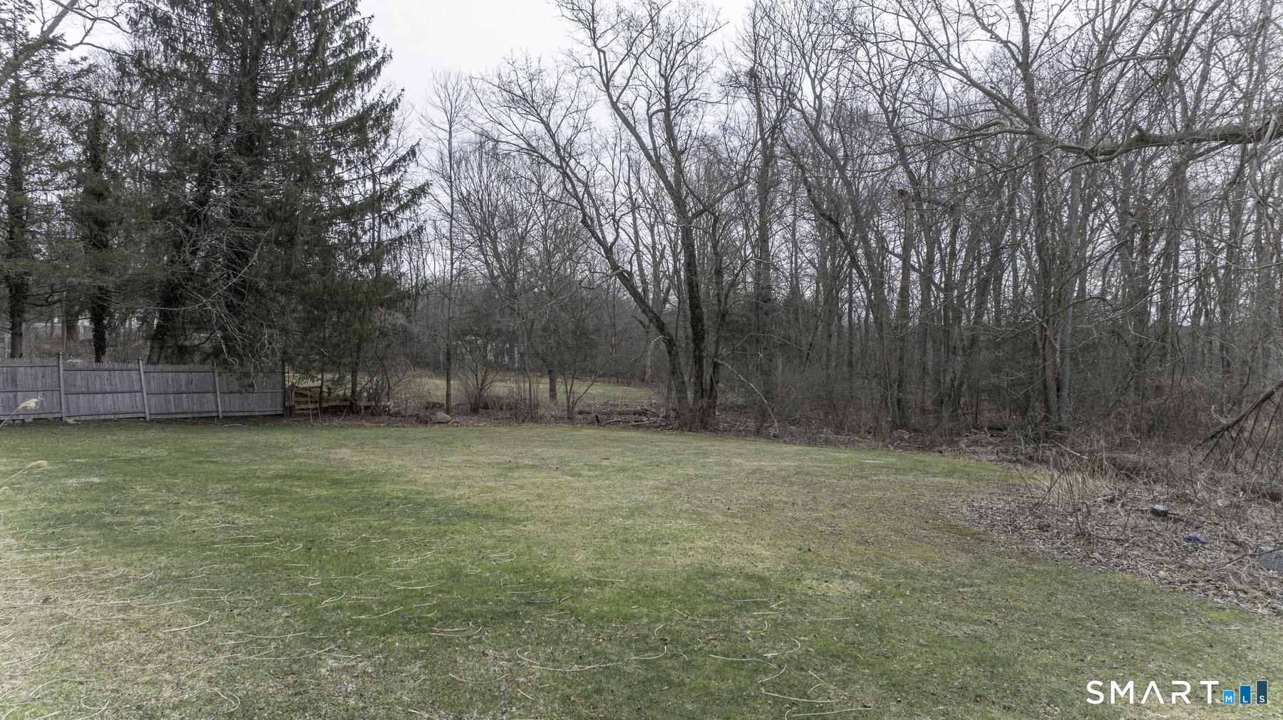 183 Sugar Street Newtown, CT 06470 - Photo 39 of 40 a backyard of a house with lots of green space