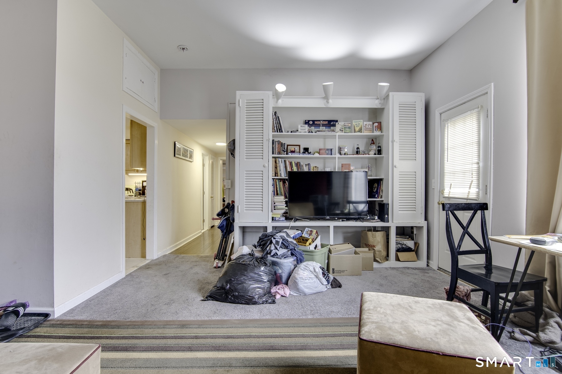 183 Sugar Street Newtown, CT 06470 - Photo 5 of 40 a living room with furniture flat screen tv and kitchen view