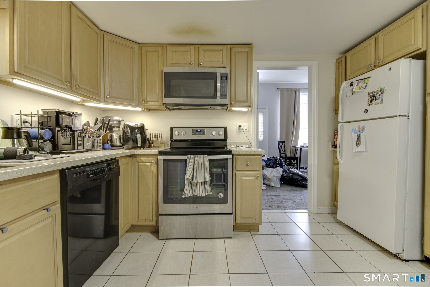183 Sugar Street Newtown, CT 06470 - Photo 7 of 40 a kitchen with a stove a sink and a refrigerator